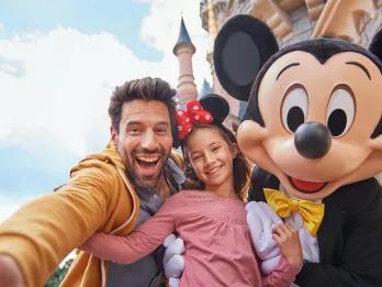 Family with Mickey in front of Sleeping Beauty Castle at Disneyland Paris