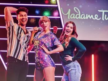 Guests posing with Taylor Swift at Madame Tussauds London