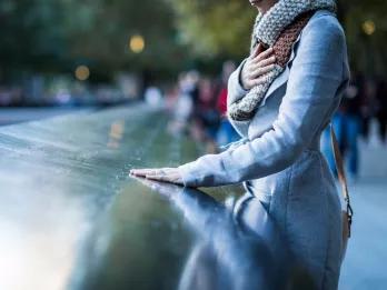 Woman by the Reflecting Pools at the 911 Memorial Museum in New York