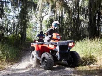 Orlando ATV Driving Experience Two people riding red ATV's in Orlando