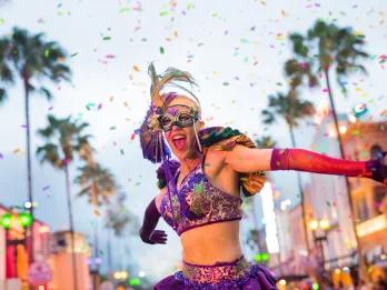 Parade performer wearing a masquerade mask in the Mardi Gras parade