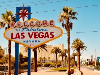 Welcome to Las Vegas Welcome to Las Vegas sign in front of blue sky and palm trees