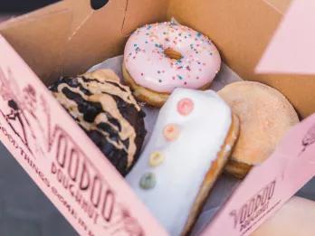 Voodoo Doughnuts A box of iced ring and filled doughnuts from Voodoo Doughnuts