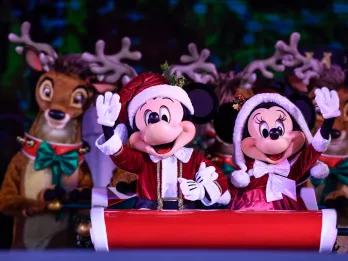 Mickey's Very Merry Christmas Party Mickey and Minnie dressed as Mr and Mrs Claus sitting in a sleigh