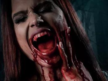 Fright Nights at Thorpe Park A woman screaming and holding her face with blood on her hands and chin
