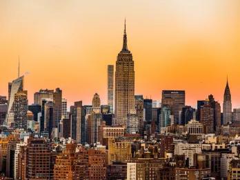 New York City Buildings in New York with the Empire State Building in the centre, during sunset