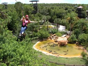 woman riding the Screamin’ Gator Zip Line at Gatorland