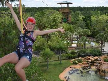 Woman riding the Screamin’ Gator Zip Line at Gatorland