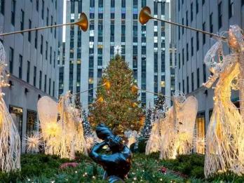 Glowing angel decorations in front of the Rockefeller Center Christmas Tree