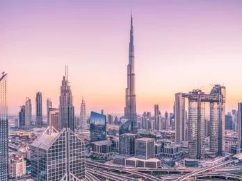 Long distance view of the Burj Khalifa and other buildings during sunset
