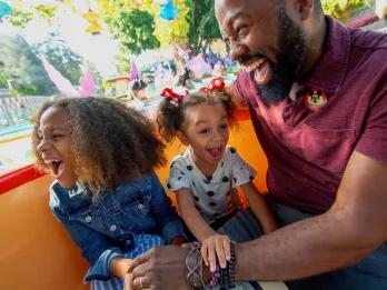 Father and daughters on Mad Tea Partym Disneyland Park in California
