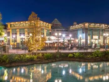 Raglan Road pub lit up at night on the other side of the water at Disney Springs