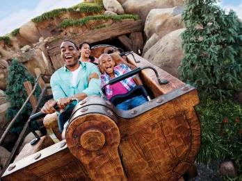 Guests on Seven Dwarfs Mine Train at Magic Kingdom Park