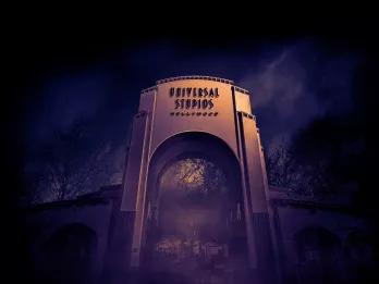 Universal Studios Hollywood Halloween Horror Nights A large archway reading Universal Studios Hollywood surrounded by fog at night