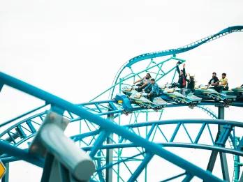 Arctic Rescue at SeaWorld San Diego People riding a coaster with ride vehicles shaped like snowmobiles on a blue track
