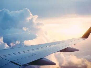 Orlando in 2024 A view out of a plane window of a plane wing in the clouds