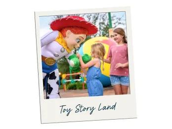 A polaroid labelled Toy Story Land with a picture of Jessie from Toy Story greeting a young girl inside