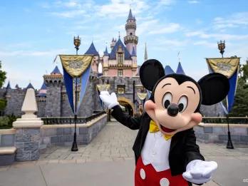 Disneyland Resort in California Mickey Mouse standing in front of Sleeping Beauty Castle at Disneyland Resort