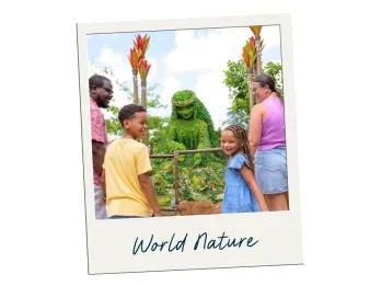 World Nature A family of four, a mum, dad, daughter and son, stood in a garden looking at a giant flower and plants statue of the goddess in Moana. She is Green and wearing a flower crown. Either side are tall plants coloured green and orange. There is a label saying "World Nature".