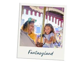 Fantasyland Image of young girl wearing purple dress sat on white carousel horse with a gold pole. The mother is standing next to her smiling brightly looking at the young girl, she is also wearing turquoise and pink mickey ears.