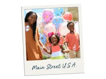Main Street U.S.A. Family with mother, daughter and son holding hands. The little girl is laughing and the others are smiling widely. Behind there are white, blue and purple balloons, some plain and some with small characters on.
