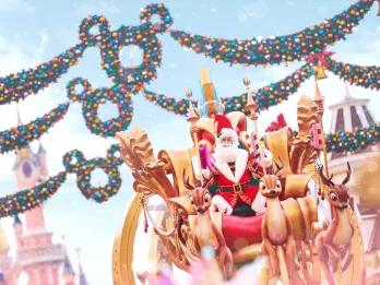 Christmas at Disneyland Paris Santa on top of a parade float in front of Sleeping Beauty Castle at Disneyland Paris