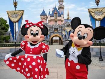 Disneyland Resort in California Mickey and Minnie Mouse posing in front of Sleeping Beauty Castle at Disneyland Resort