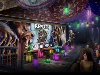 Concept art of a roller coaster going past a sign reading Beware of the Moon