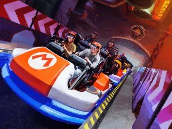 Concept art of people riding a Mario Kart attraction wearing VR goggles