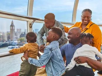 Visiting London with Kids A family looking at Big Ben and the Thames from the London Eye