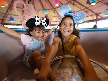 Mad Tea Party Two young girls in a spinning tea cup ride