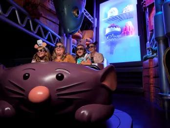 Remy's Ratatouille Adventure A family in a ride vehicle shaped like a large cartoon rat