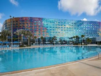 Stella Nova Resort Exterior of Stella Nova and large pool. The outside is full of multi-coloured mosaic tiles of different colours.