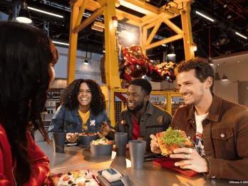 A group of friends eating in Stark Factory at Disneyland Paris