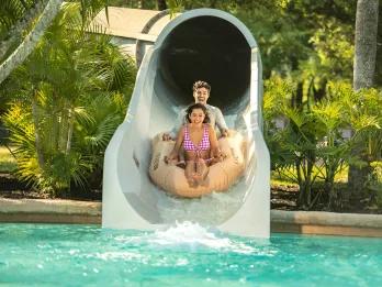 Crush 'n' Gusher A couple on a raft coming out of a water slide
