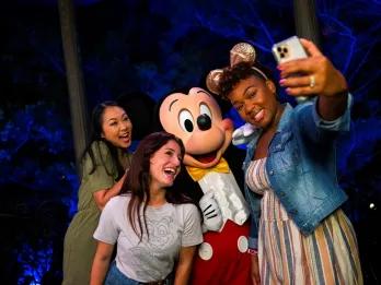 Disney After Hours at EPCOT A group of friends taking a selfie with Mickey Mouse