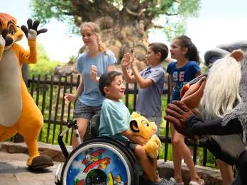 A group of young children meeting Timon and Rafiki from The lion King