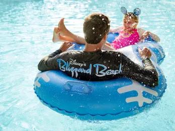 Cross Country Creek A man and girl sat in a raft in a lazy river at Disney's Blizzard beach