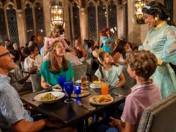 A family eating at a restaurant meeting Jasmine from Aladdin