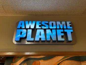 Awesome Planet A sign for a theme park attraction called Awesome Planet