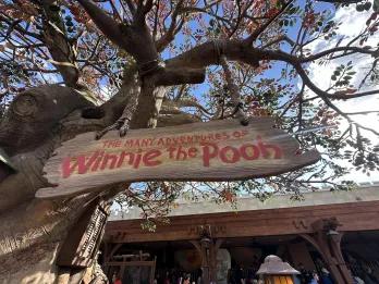 The Many Adventures of Winnie the Pooh A sign outside a theme park attraction called The Many Adventures of Winnie the Pooh