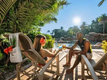 Rest and Relaxation at Discovery Cove A couple drinking cocktails while sitting on sunloungers