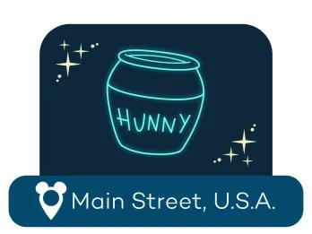 Der Umriss eines Honigtopfes mit der Aufschrift „Hunny“ über einem Ortsschild für Main Street USA