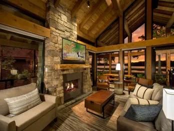 A living room in a wood cabin with large windows