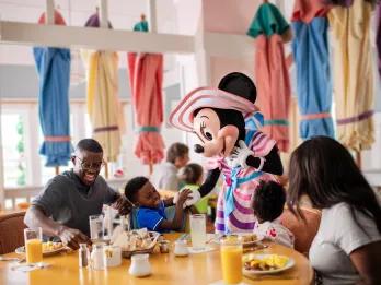 Character Dining A family eating breakfast while meeting Minnie Mouse