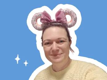 smiling female with pink mickey mouse ears, on a blue background
