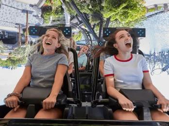 Two young women with open mouths on an inversion on VelociCoaster