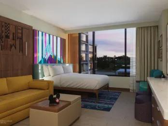 Modern, sleek hotel room with colourful bed headboard and a lovely view.