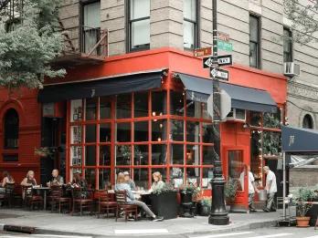 Red restaurant with people sitting dining outside in New York City