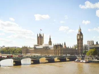 Houses of parliament on the side of the River Thames with Big Ben.